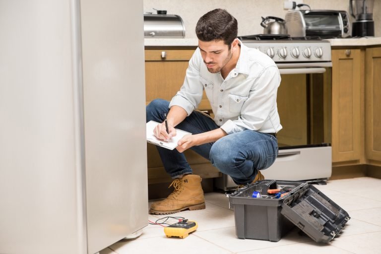 Male technician writing a work report